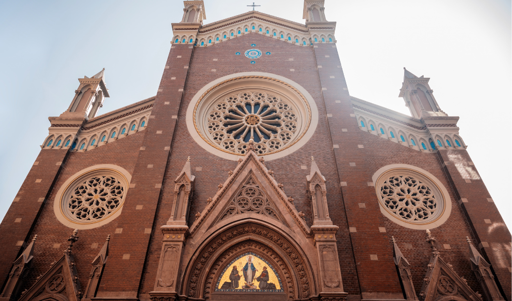 Exterior of ornate building with stained glass and towers